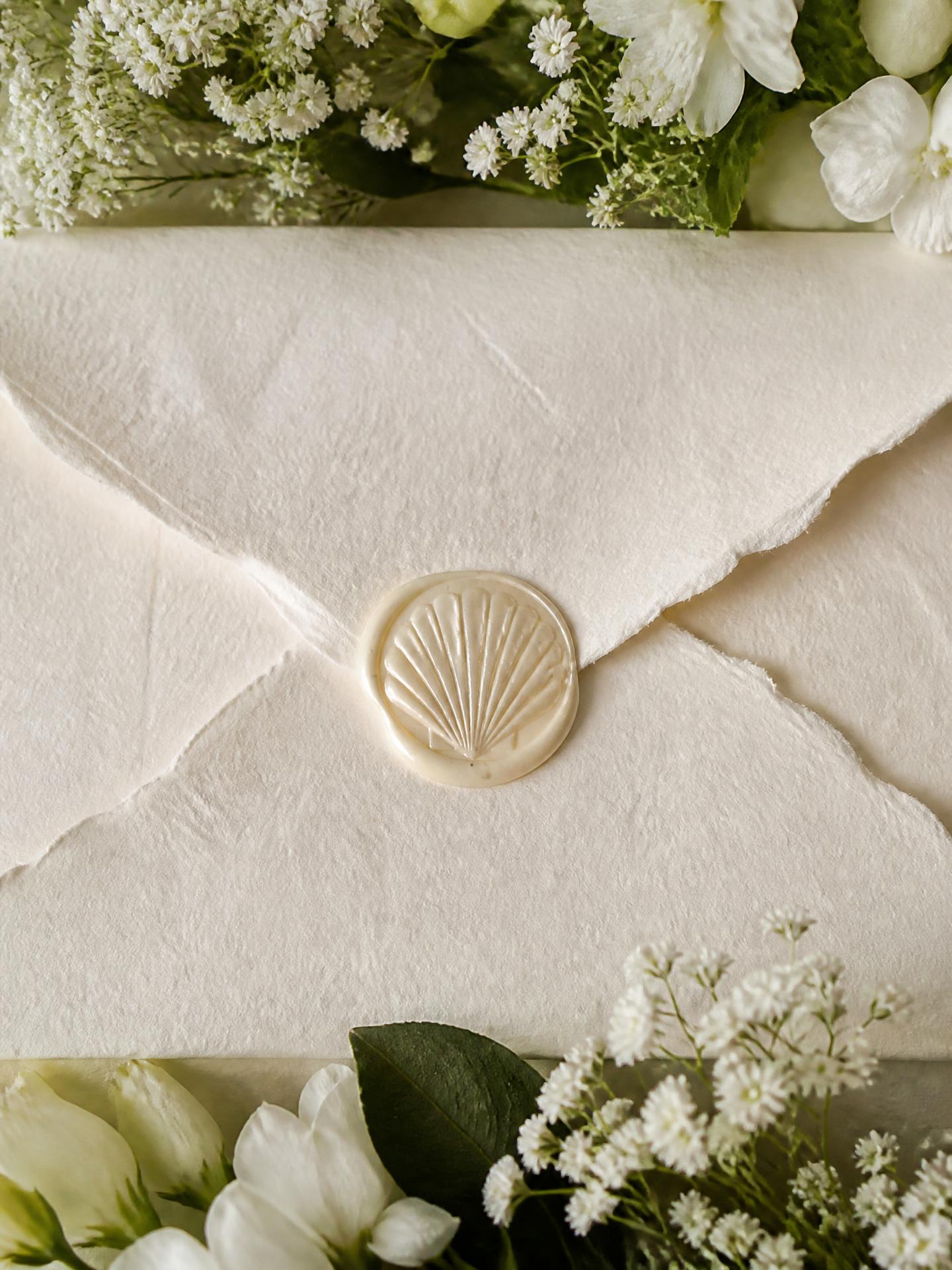 Wedding invitation envelope with a shell wax seal